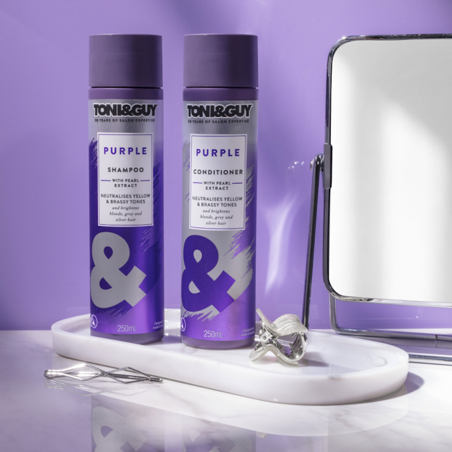 Stylish display of Toni & Guy Purple Shampoo and Purple Conditioner bottles on a white tray